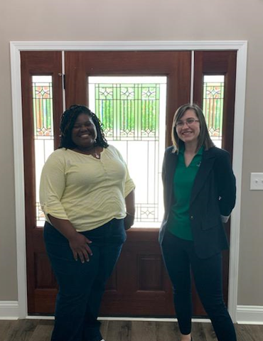 Photo of employee Ariel Bowley and customer Crystal Ivory in her new home.